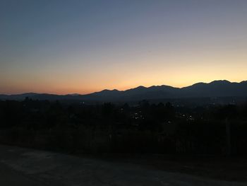 Scenic view of silhouette mountains against sky at sunset