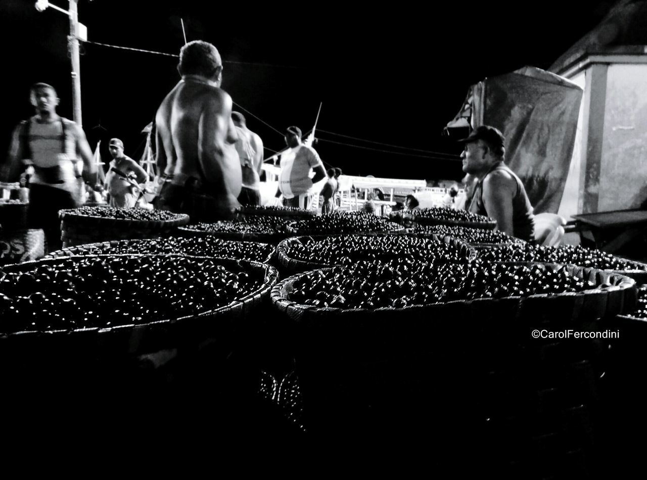 statue, sculpture, human representation, men, night, art and craft, art, outdoors, low angle view, incidental people, market, built structure, market stall, animal representation, building exterior, architecture, street