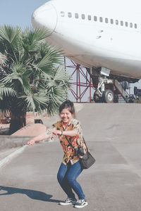 Portrait of smiling young woman on road