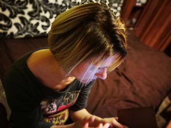 Close-up of senior woman sitting at home