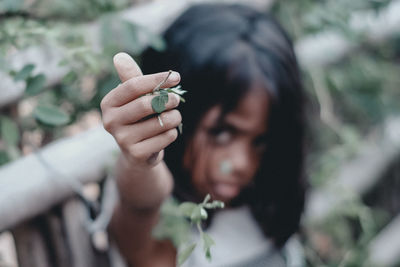 Close-up of hand holding plant