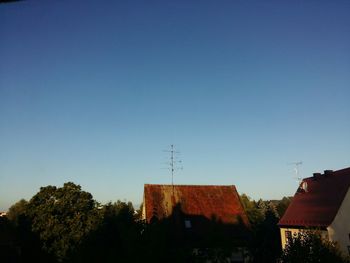 High section of houses against clear blue sky