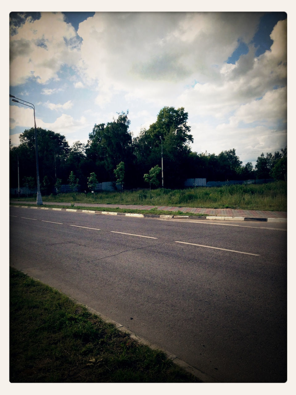 transfer print, sky, tree, road, the way forward, transportation, auto post production filter, cloud - sky, street, cloud, cloudy, road marking, empty, tranquility, diminishing perspective, country road, grass, asphalt, tranquil scene, nature