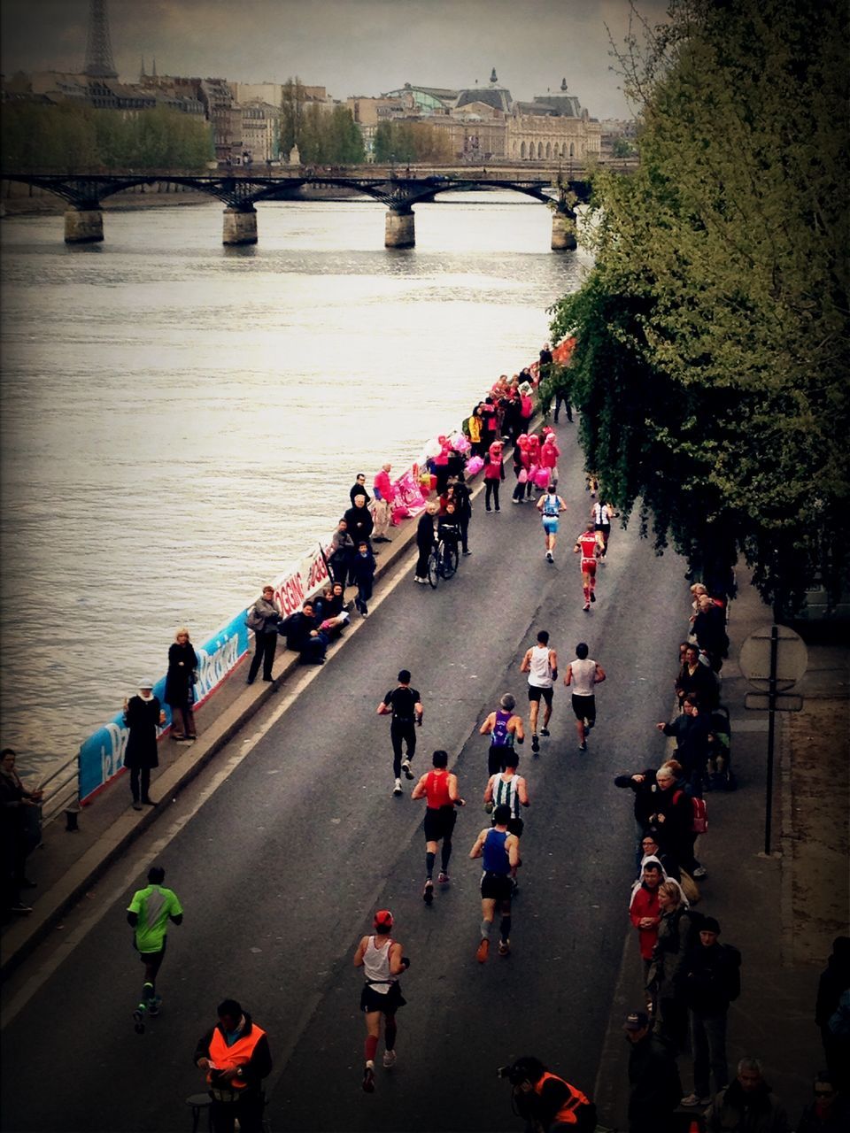 large group of people, high angle view, transportation, bridge - man made structure, connection, river, men, water, person, mixed age range, lifestyles, mode of transport, built structure, leisure activity, travel, architecture, railing, bridge, bicycle