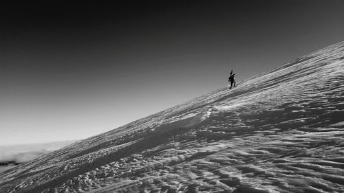 Low angle view of person standing on snow covered landscape