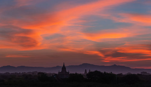 Silhouette temple against sky during sunset