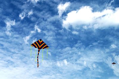Low angle view of kite flying against sky