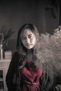 Portrait of beautiful young woman standing at night
