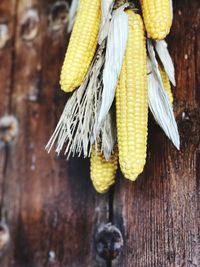 Close-up of corns hanging on wooden wall