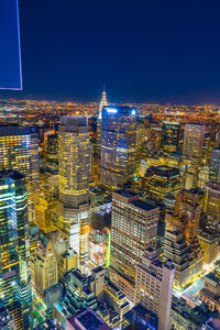 High angle view of illuminated buildings against sky at night