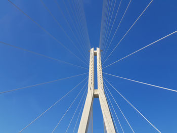 Low angle view of bridge against clear blue sky