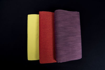 High angle view of multi colored pencils on black background