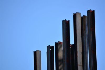 Low angle view of buildings against clear blue sky