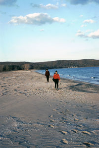 Two women walking on the beach