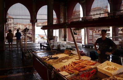 People working at market stall