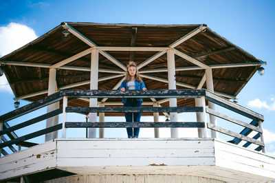 Low angle portrait of woman standing in at observation point