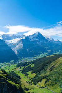 Scenic view of mountains against blue sky