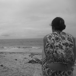 Rear view of man standing on beach