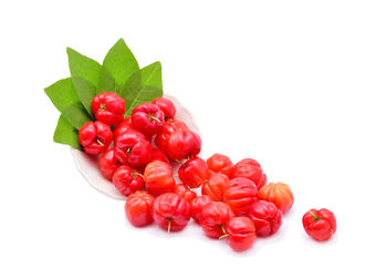 Close-up of cherries over white background