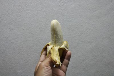 Peeled banana on a hand