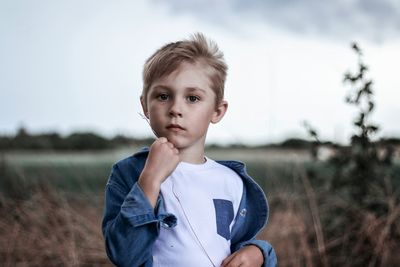 Portrait of boy standing on field