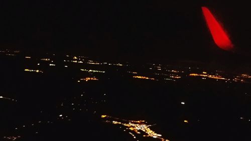 Illuminated cityscape against sky at night