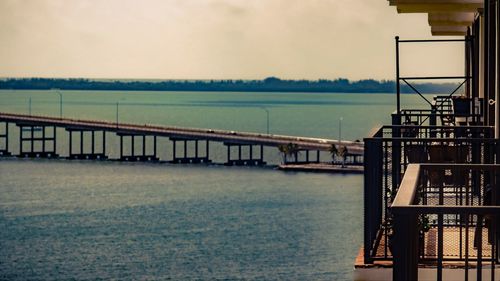 Bridge over sea against sky seen from balcony