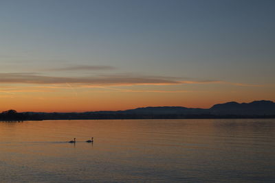 Scenic view of lake against sky during sunset