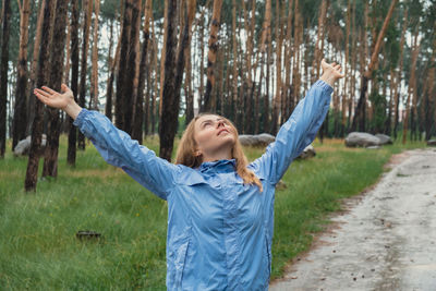 Portrait of woman standing in forest