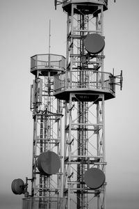 Low angle view of communications tower against sky