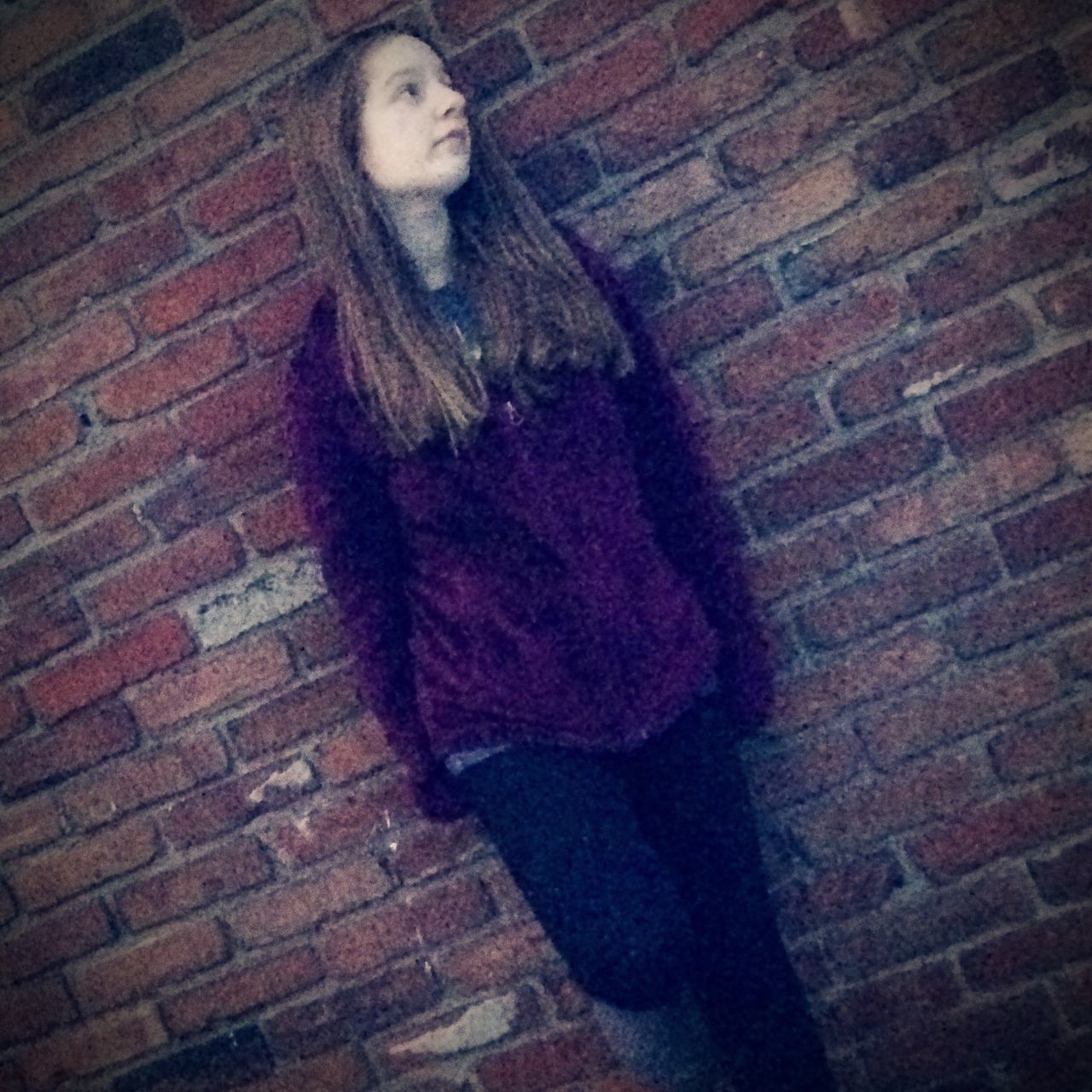 young adult, person, lifestyles, young women, casual clothing, wall - building feature, standing, brick wall, three quarter length, leisure activity, front view, full length, portrait, sitting, indoors, looking at camera, built structure