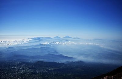 Scenic view of snowcapped mountains against clear blue sky