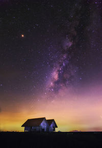 Scenic view of house against sky at night