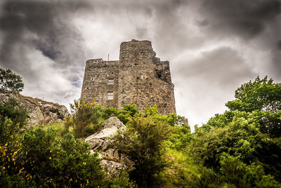 Low angle view of fort against cloudy sky