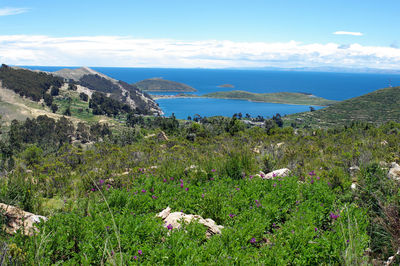 Scenic view of sea and mountains against sky