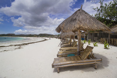 Lifeguard hut on beach against sky