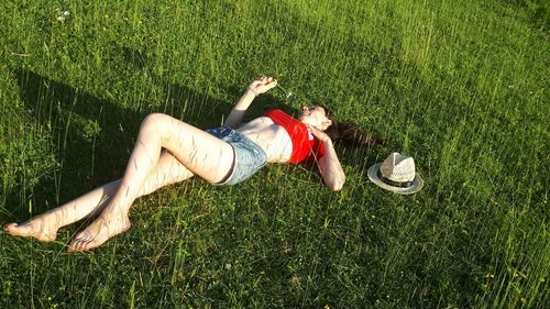 High angle view of young woman lying on land