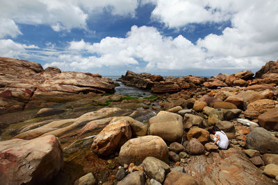 Rocks on shore against sky