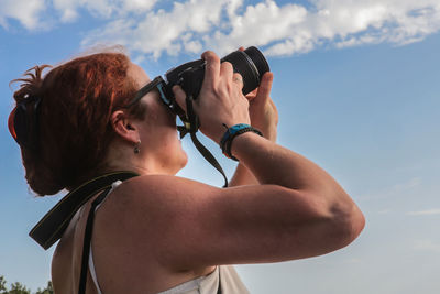 Portrait of woman photographing