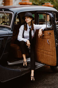 Portrait of smiling woman sitting in car