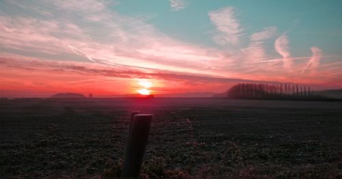 Scenic view of field against sky during sunset