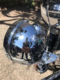 Reflection of man photographing in mirror