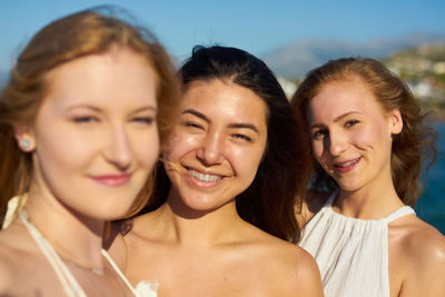 Portrait of happy female friends during sunny day