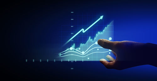 Cropped hand of man holding illuminated lights