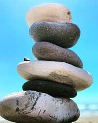 Close-up of stacked coins against blue background