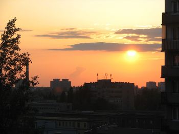 Silhouette buildings against sky during sunset