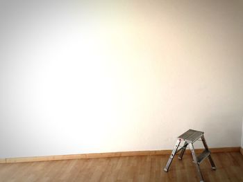 Stool on floor against wall at home