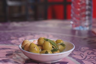 Close-up of pickled olive in bowl on table