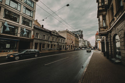 Cars on street amidst buildings in city