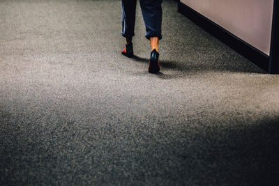 Low section of woman standing on tiled floor